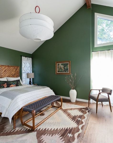 an attic mid century modern bedroom with green walls, wood and rattan furniture, an oversized lamp and a printed rug Green Bedroom Walls, Green Bedroom Design, Green Bedroom Decor, Airy Bedroom, Green Accent Walls, Green Interior Design, Lakeside Cabin, Gorgeous Bedrooms, Attic Bedroom