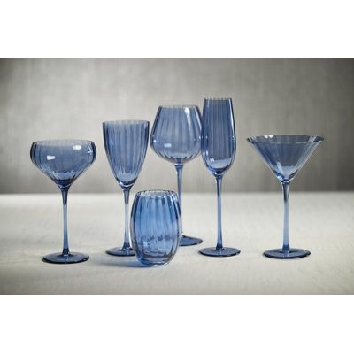 Crafted of beautifully textured glass, the colored glass set features a streamlined design with a pop of color. Raise a toast with these champagne flutes; a fun and stylish interpretation of the tradition and ideal for serving champagne, spumante or sparkling wine. Orren Ellis Color: Blue Azure Orren Ellis Malden Optic Champagne Flutes, Set of 4 - Glassware & Barware in Blue Azure | Birch Lane Drinking Glasses Design, Blue Glassware, Champagne Flute Set, White Wine Glasses, Red Wine Glasses, Wine Glass Set, Glassware Collection, Cocktail Glass, Champagne Flutes