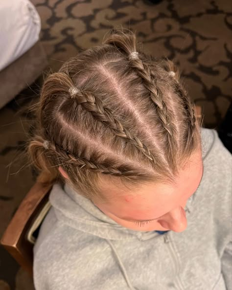 Four small Dutch braids are shown in light brown hair. Braids For Wrestling, Braided Hairstyles For Gymnastics, Braided Hairstyles For Dance Competitions, 4 Dutch Braids Hairstyles, Braids For Gymnastics, College Gymnastics Hair, Figure Skating Hairstyles Competition, Girls Wrestling Hairstyles, Four Dutch Braids