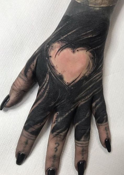 Dope blackwork handtattoo with heart in between by our good friend @youngheartedtattoo Black Out Hand Tattoo, Hand Tattoo Cover Up, Gotik Tattoo, Feminine Skull Tattoos, Shadow Tattoo, Feminine Tattoo Sleeves, Knuckle Tattoos, Blackout Tattoo, Wicked Tattoos