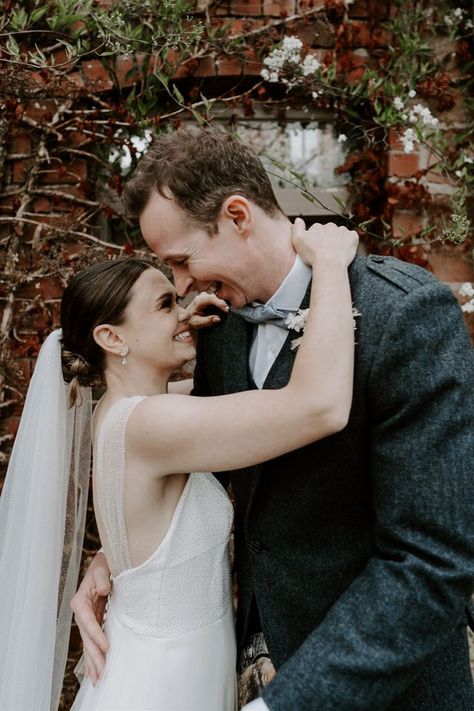 Groom in navy suit jacket and kilt and pale blue paisley bow tie smiles down at the bride who wears a sparkly wedding dress and veil Pampas Grass Diy, Cute Couple Wedding, White Dried Flowers, Wedding Dress And Veil, Barn Wedding Inspiration, Family Wedding Photos, Groomsmen Outfits, Sparkly Wedding Dress, Sparkly Wedding