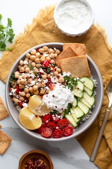 garnished chickpea bowl on a yellow linen towel Greek Bowl Chickpeas, One Plate Meal, Chickpea Greek Bowl, Balance Bowl Recipe, Chickpea Bowls, Balanced Bowls, Chickpea Bowl, Greek Chickpeas, Food Bowl