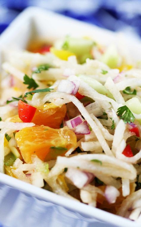 Crunchy, refreshing Jicama Salad with julienned jicama, bell peppers, red onion, cucumber, orange, and lime juice. Perfect accompaniment to Mexican food dishes. Pineapple Jicama Salad, Beet And Jicama Salad, Jicama Coleslaw Slaw Recipes, Jicama Orange Salad, Jicama Salad, Jicama Slaw, Mexican Food Dishes, Spanish Onion, Bell Peppers