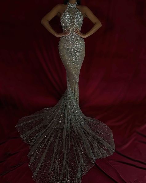 To purchase this stunning gown, send us a DM at @reineecouture. This show-stopping, form-fitting gown is the epitome of red carpet glamour. Featuring a high halter neckline, the gown is encrusted with shimmering crystals that catch the light from every angle, creating a dazzling, head-turning effect. The crystal embellishments are intricately placed to enhance the body’s natural curves, while the sheer mesh fabric adds a sultry touch of sophistication. The fitted silhouette hugs the figure ... Lena Berisha, Halter Neck Gown, Nude Gown, Silver Gown, Gold Gown, Silver Mermaid, Strapless Sweetheart Neckline, Embellished Gown, Sequin Gown