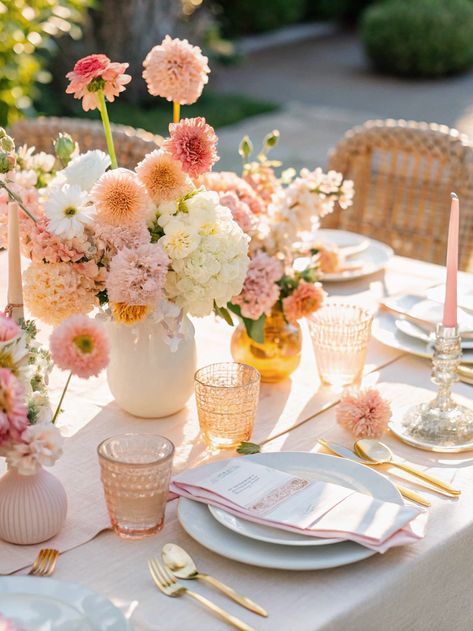 A simple wedding flower arrangement featuring a blend of pink and orange flowers. The colors work well for a pink and orange spring wedding or a sunset floral wedding theme. This arrangement can be used as a colorful centerpiece for a wedding table or as part of the overall floral decor. Save this pin for your wedding planning! Pink Orange Yellow Floral Arrangement, Wedding Table Covers, Pink And Orange Wedding Flowers, Orange Spring Wedding, Spring Wedding Table Decor, Orange Pink Wedding, Spring Wedding Flowers Centerpieces, June Wedding Ideas, Spring Centerpiece Ideas