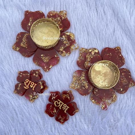 ✨ Diwali Special Resin Hampers ✨ Looking for the perfect blend of tradition and elegance? Our handmade resin hampers are just what you need! 💙 This set features: 🌸 Stunning flower tealight holders to light up your home. 🌸 Delicate Shubh Labh hangings for your entryway. 🌸 Pagaliya coasters adorned with pearl detailing, symbolizing auspicious beginnings. Each piece is crafted with love, gold accents, and a touch of luxury to elevate your festive decor. DM us for customizations and orders! 🕯️💫 ... Diwali Special, Festive Decor, Tealight, Tea Light Holder, Festival Decorations, Gold Accents, Diwali, Tea Lights, Light Up