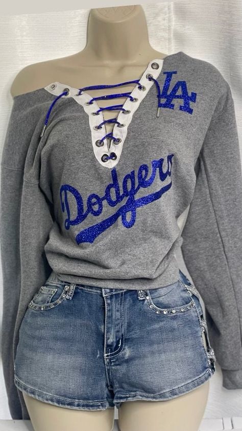 Dodgers off the shoulder shirt with blue glitter lace   Please note estimated time to ship these items is 7-10 business days as they are made to order. If you need it right away please send us a message and we will try our best to accommodate your request. Dodger Outfit, Off The Shoulder Tshirt, Dodger Outfits For Women, Dodgers Outfit Women, Dodger Shirt, Dodgers Tshirt, Dodgers Outfit, Womens Dodgers Shirt, Easy Diy Clothes