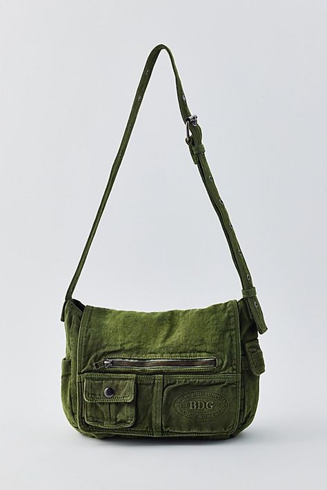 Essential messenger bag crafted from premium BDG denim. Low-profile silhouette with a pocketed flap closure. Lined interior with two pockets and plenty of space for your essentials. Complete with a zip pocket at the back for easy access, plus a water bottle pocket at the side. Finished with an adjustable strap - wear it on your shoulder or crossbody. Urban Outfitters exclusive. Features BDG denim messenger bag Washed soft denim with tons of storage Plenty of pockets inside and out Water bottle pocket Adjustable strap UO exclusive Content + Care Cotton Spot clean Imported Size Dimensions: 11" l x 4" w x 10" h Strap drop: 21" | BDG Denim Messenger Bag in Olive Wash, Women's at Urban Outfitters Cross Body Bags Outfit, Bags With Pockets, Bags Inspiration, Patchwork Crossbody Bag, Messager Bag, Cool Bag, Messenger Bag Outfit, Messenger Bags, Side Bag