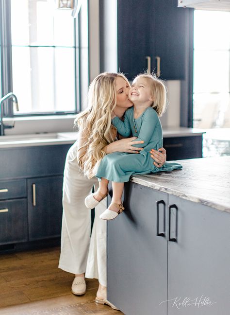 mom kissing young daughter sitting on kitchen counter Mom And Daughter Kitchen Photoshoot, Family Photos Lifestyle Indoor, Kitchen Family Pictures, Family Pictures In Kitchen, Kitchen Family Photos, Family Photos In Kitchen, Family Portrait At Home, Family Photo Shoot At Home Ideas, Family Photo Shoot At Home