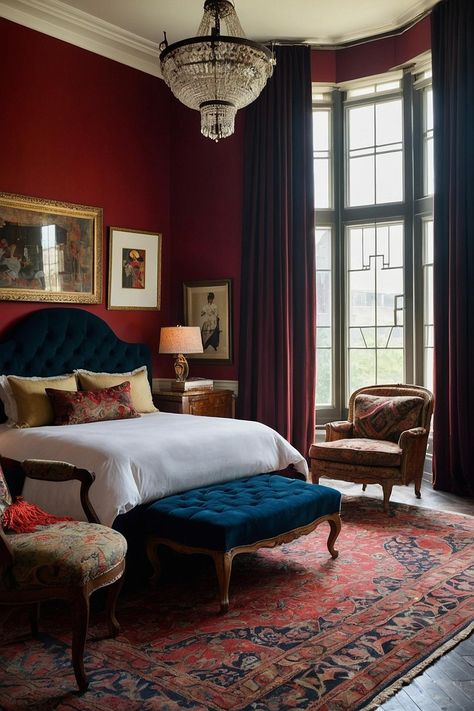 Step into a realm of timeless elegance with this stunning bedroom design! The rich, deep red walls create a warm and inviting atmosphere, while the tufted teal headboard adds a touch of sophistication. Complemented by vintage artwork and a crystal chandelier, this space exudes classic charm. The ornate rug and cozy seating invite you to relax and unwind, making it the perfect retreat for restful nights. #homedecor #homeinterioir #interioirdesign #bedroomdesign #luxurybedroom Victorian Red Bedroom, Jewel Tone Master Suite, Red Carpet Bedroom Ideas, Red Wall Bedroom Ideas, Red Walls Bedroom, Deep Red Bedroom, Dark Red Bedroom Aesthetic, Dark Red Room Aesthetic, Blue And Red Bedroom