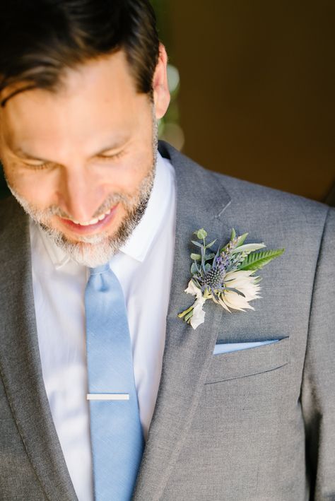 Blue Thistle Boutonniere & Tie | Photo: Karlisch Photography. Bouteniere Wedding, Pastel Boutonniere Wedding, Thistle Boutineer, Dusty Blue And Mauve Boutonniere, Pastel Boutonniere, Dusty Blue And Pink Boutonniere, Pastel Pocket Boutonniere, Wildflower Boutonniere, Rustic Wedding Suit