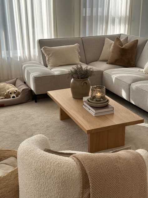 Coffee table styling, teddy chair, wooden coffee table, neutral interior, grey couch, golden retriever puppy Grey Couch Light Wood Coffee Table, Grey Couch Wood Coffee Table, Grey Couch Coffee Table Ideas, Wood Coffee Table Aesthetic, Teddy Couch Living Room, Coffee Table With Beige Couch, Coffee Table Grey Couch, Coffee Table With Grey Couch, Poland Apartment