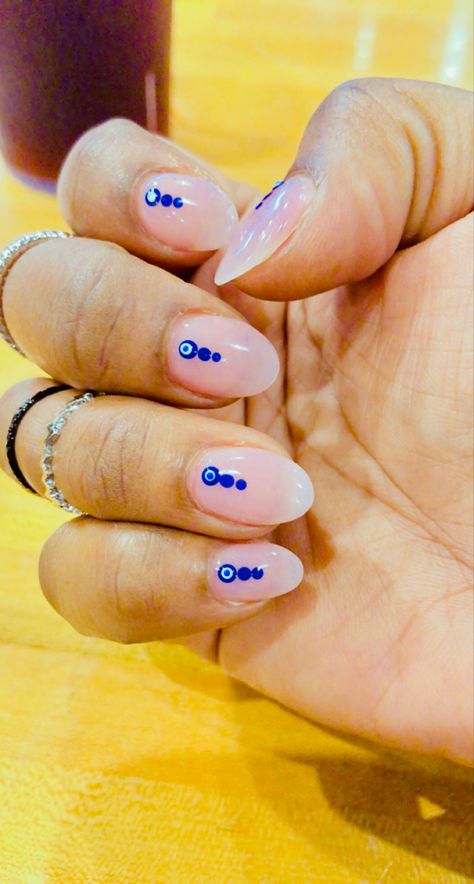 One of my favorite sets ever 😍! We went with a sheer pink base, a simple blue dot design with the evil eye, pretty & protected. 🧿💙💅🏾 #almondnails #simplenails #neutralnails #naildesign #nailideas #bluenailart #pinknails Simple Nail Art Evil Eye, Evil Eye Almond Nails Designs, Evil Eye Accent Nail, Evil Eye Manicure Nail Designs, Evil Eye Nails With Gold, Orange Evil Eye Nails, Nails Dots Designs, Evil Eye Cake, Blue Nails Evil Eye