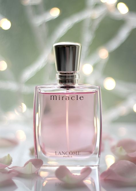 Opens with sweet notes of lychee and freesia sharpened by ginger and pepper.  Jasmine and magnolia dry down to musk and amber. Miracle Lancome Perfume, Lancome Miracle Perfume, Miracle Perfume, Lancome Perfume, Armani Fragrance, Fragrance Photography, Perfume Display, Perfume Photography, Perfume Floral