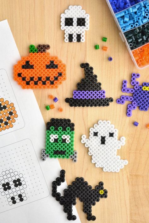 These Halloween Perler beads creations are so much fun to make! Follow our FREE, printable Halloween Perler bead patterns, or design your own Halloween pixel art using fuse beads! It's such a fun kids craft and activity, and you can easily make these Halloween Perler beads into a keychain or magnet for an awesome homemade gift. Perfect for birthday parties, sleepovers, or a rainy fall day! Halloween Iron Beads, Fall Perler Bead Patterns, Halloween Hama Beads, Halloween Perler Bead Patterns, Halloween Perler Beads, Halloween Perler, Diy Pumpkins Crafts, Rave Ideas, Rainy Fall