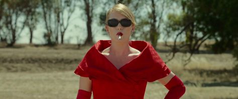 The Dressmaker (2015) - Kate Winslet as Tilly Dunnage wearing a front-buttoned scarlet red moiré overcoat with shawl collar over a sheath dress with fitted bodice.  The costumes were designed by Margot Wilson. The Dressmaker Movie, Tv Costume, The Dressmaker, 1990 Style, Amazon Prime Movies, Amazon Prime Shows, Prime Movies, Sarah Snook, Hugo Weaving