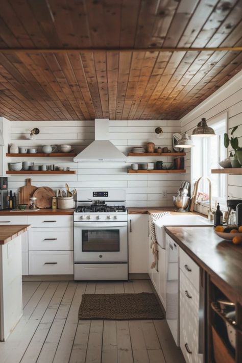 If you're looking to revamp your kitchen, why not consider adding a stunning shiplap ceiling? This design trend introduces a level of farmhouse charm or modern sophistication that'll make your space irresistible. From traditional white for a timeless appeal to bold, dark wood adding a dramatic flair, the possibilities are endless. Perfect for DIY enthusiasts or homeowners looking to enhance their kitchen ambiance, these shiplap ceiling ideas bring warmth and texture to every meal. Explore these stylish ideas and get inspired! Wood Ceilings Farmhouse, Wooden Ceiling In Kitchen, Kitchen With Wooden Ceiling, Cedar Ceiling Kitchen, Natural Wood Shiplap Ceiling, Wood Ceilings Kitchen, Wooden Ceiling Kitchen, Shiplap Kitchen Ceiling, Beadboard Ceiling Kitchen