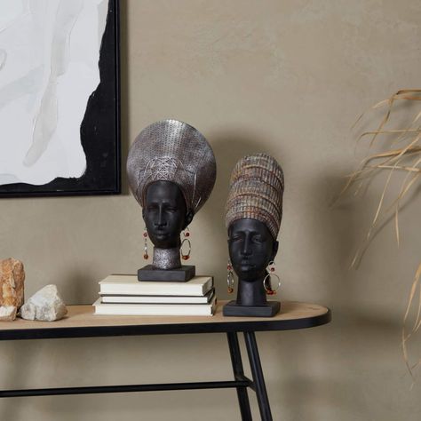 "Buy the Black Polystone African Inspired Women Sculpture Set at Michaels. com. The decorative women sculptures highlight a matte black finish with distressed metallic silver and patina headdresses. The table top sculptures showcase a versatile pairing of African women's heads designed with geometric earrings, large headdresses and a rectangular base stand. Express your personality with eclectic design and transform your space into a diverse mixture of colors and patterns. Eclectic head sculptur Black Aesthetic House Interior, Black Aesthetic House, Mask Sculpture, Woman Sculpture, Head Table Decor, African Sculptures, Elephant Sculpture, African Decor, Decorative Sculpture