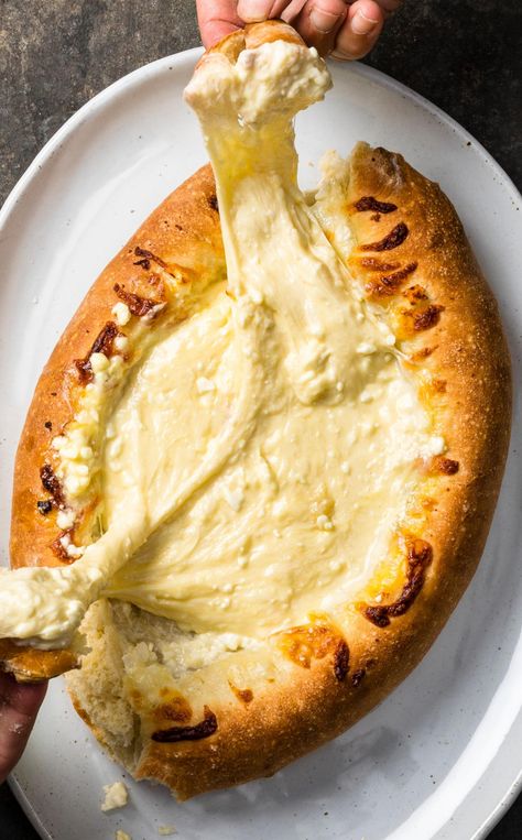 Adjaruli Khachapuri: Crusty bread filled with gooey cheese? Sounds like a party to us. Adjaruli Khachapuri, Khachapuri Recipe, Simple Pizza Dough, Simple Pizza, Cooks Country Recipes, Donut Toppings, Georgian Food, Easy Pizza Dough, Cookie Toppings