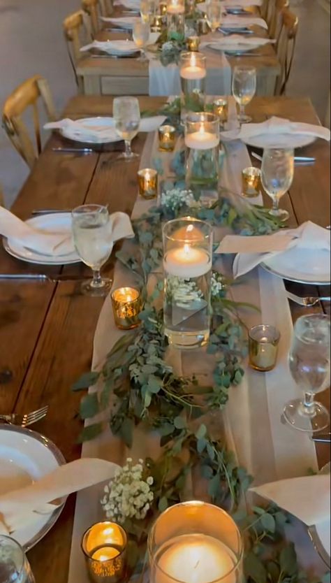 Greenery, floating candles, simple tie knot napkins Wedding Table Centerpieces For Long Tables, Wedding Table Set Up Rectangle, Floating Candles Wedding Table Decor, Floating Candles Tablescape, Simple Outdoor Table Centerpieces, Wedding Centerpieces Flameless Candles, Long Wedding Table Decorations Simple, Wedding Reception Rectangle Tables, One Long Wedding Dinner Table