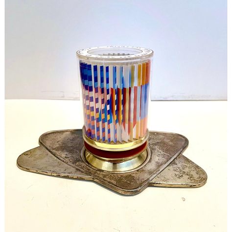 This is a revolving colorful kiddush cup with a signed and numbered Agam op art print in it.  this includes the base tray. There is no cup insert so it is more of a sculptural piece than a functional kiddush cup.  biographical info: The son of a rabbi, Yaacov Agam can trace his ancestry back six generations to the founder of the Chabad movement in Judaism. in 1946, he entered the Bezalel Academy of Arts and Design in Jerusalem. Studying with Mordecai Ardon, a former student at the Weimar Bauhaus Yaacov Agam, Kiddush Cup, Max Bill, Marcel Duchamp, Josef Albers, The Bauhaus, The Masters, Snl, Op Art