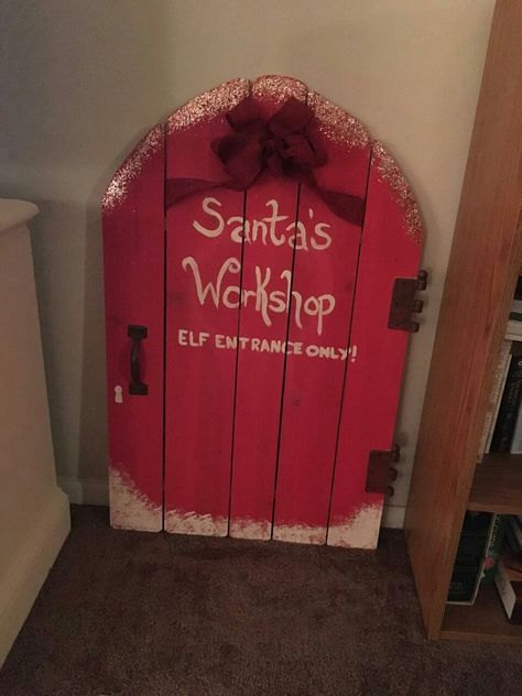 Rustic DIY Santa's Workshop Elf Entrance Only Door so easy! Santas Workshop Diy Christmas Decor, Santa's Workshop Door Decoration, Office Door Christmas Decorations Ideas Gnome, Christmas Decor Santas Workshop, Santas Workshop Outdoor Decor, Santa’s Grotto Diy, Elf Workshop Ideas, Garage Door Decorations For Christmas, Santas House Diy