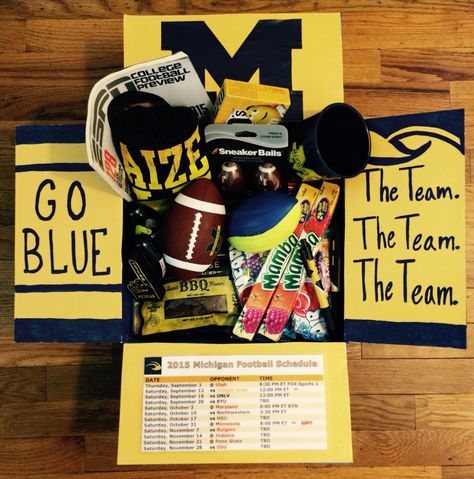 Michigan football care package. #deployment #military #collegefootball Game Day Care Package Football, Fall Camp Basket Football Boyfriend, Fall Camp Basket Football, Football Care Package Boyfriends, Football Care Package, Yellow Gifts Basket, Senior Boxes, Care Package Decorating, Bf Things