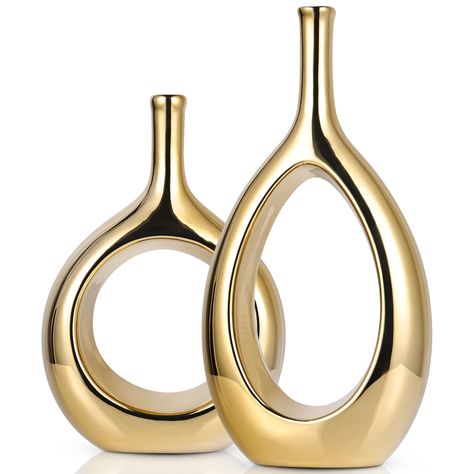 PRICES MAY VARY. 【Glossy Gold Decor Vase】Contemporary home decor is a widely popular mid-Century Modern Ellipse Hollow Vase, These small vases are perfect for your entryway, coffee table, shelf, mantle, accent table, and much more. They will look great no matter the season or Holiday! Create a space in your home with refined Fashion home décor accents, Create a warm atmosphere in your home. 【Modern Gold Vases】Our Light Luxury Ceramic Glossy Gold Vases 2-Piece Set,They come in different shapes an Gold Vase Decor, Small Vases, Gold Centerpieces, Gold Vase, Vase Ceramic, Gold Vases, Pampas Gras, Luxurious Home, Gold Ceramic