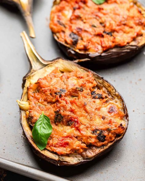 Stuffed eggplants are loaded with rich Sicilian flavor! Roasted eggplant, breadcrumbs, pine nuts, raisins, tomatoes, cheese, basil and mint are combined and stuffed into hollowed out eggplant shells and baked until golden. So simple and so good! #stuffedeggplant #eggplantrecipes #italianstuffedeggplant Eggplant Boats, Recipes Squash, Sip And Feast, Stuffed Eggplant, Roasted Eggplant, Roast Eggplant, Fennel Salad, Cheese Stuffed, Eggplant Recipes