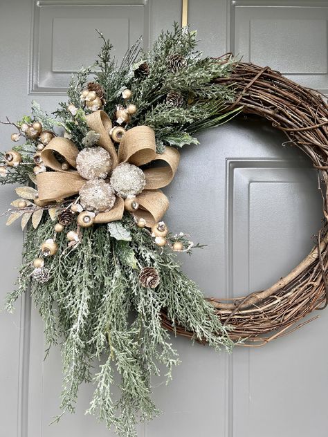 "New for the holidays is this elegant wreath, all decked in gold and ready to help you welcome your family and friends this holiday. The gold-flocked berries create a festive look on the wreath with the glistening evergreen cypress branches.  I added frosted holly branches to accent the platinum ornaments I placed on a beige bow with sparkling gold.  I used an 18\" grapevine wreath and quality faux branches to create this unique design that is perfect for your holiday decor and to enjoy through the winter season.  Please keep in mind that if you display it on your outside door, it should have coverage from the elements, such as rain, snow, sleet, or harsh weather conditions to preserve the beauty of your wreath. Thank you for taking the time to visit this listing.  I appreciate your intere Modern Christmas Door Decor, Chic Christmas Wreath, Minimalist Winter Wreath, Christmas Wreaths Grinch, Boho Christmas Wreaths For Front Door, Christian Christmas Wreath, Christmas Neutral Decor, Christmas Wreaths Diy Easy How To Make, Christmas Wreaths For Front Door Elegant