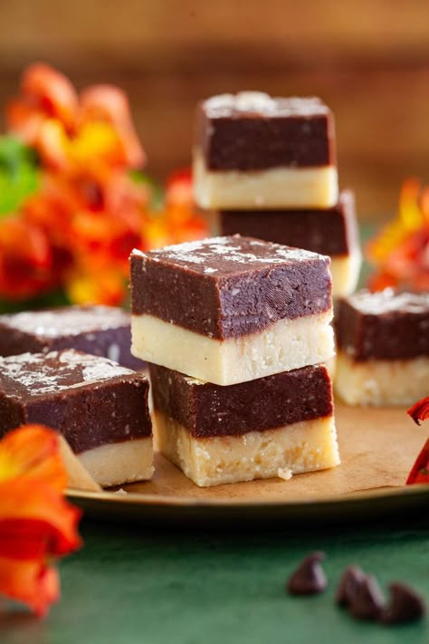 Two pieces of chocolate burfi stacked on each other with orange flowers in background. Recipes With Milk Powder, Chocolate Barfi, Indian Goat, Chocolate Burfi, Diwali Mithai, Goat Curry, Barfi Recipe, Diwali Recipes, Mutton Curry