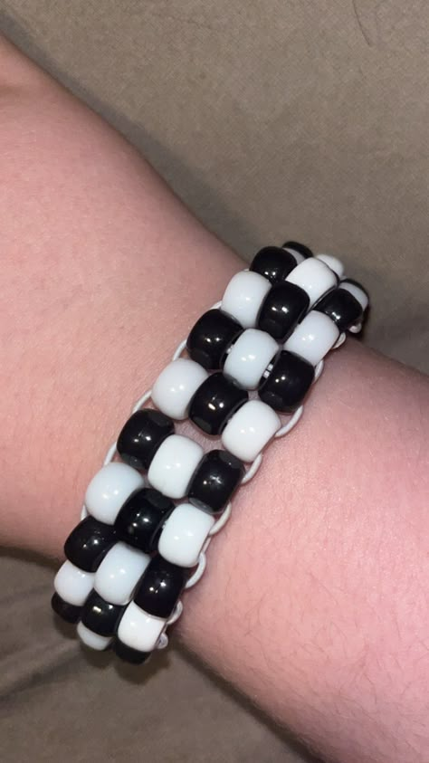 3 bead thick black/white ladder/flat stitch Kandi Cuff If you purchase the custom colors, please leave what colors you want in the personalization, or just message me Punk Kandi Bracelets, Kandi Star Bracelet, Kandi Ladder Stitch, Checkered Kandi Cuff, Kandi Cuff Designs, Emo Kandi Ideas, Simple Kandi Pattern, Kandi Inspo Cuff, Emo Kandi Bracelets