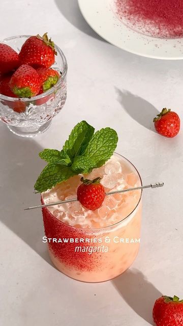 Kelly Pettit on Instagram: "Strawberries & Cream Margarita 🍓☁️ I had no idea that the mandarin cream marg recipe would be such a hit! Thank you for all of the love 🫶🏼 if you were a fan of that recipe, this strawberries & cream marg is for you!  1 1/2 oz tequila 5-6 small strawberry slices 1 oz coconut cream 3/4 oz lime juice 1/2 oz Cointreau 1/2 oz agave  Mocktail Version: 1 1/2 oz Ritual Tequila Alternative 5-6 strawberry slices 1 oz coconut cream 3/4 oz lime juice 1/4 tsp orange extract 1/2 oz agave Garnish: lime juice & crushed dehydrated strawberry  Method: add strawberry slices and tequila to a cocktail shaker and muddle. Add in the rest of the ingredients, add ice, and shake. Rim a glass with a spritz of lime juice (I use a small spray bottle) and crushed dehydrated strawberry. Do Strawberries And Cream Margarita, Strawberry Kiwi Mocktail, Strawberry Cocktail Garnish, Marg Recipe, Strawberry Tequila, Small Spray Bottle, Strawberry Margarita Recipe, Passion Fruit Margarita, Strawberry Cocktails