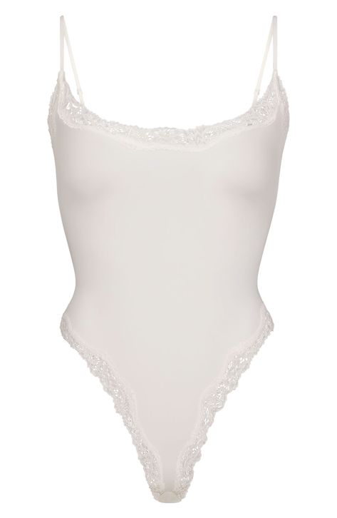 From Kim Kardashian's iconic SKIMS comes this lace-trimmed bodysuit with a scoop neck and sultry high legs. Adjustable straps 89% nylon, 11% spandex Machine wash, tumble dry Imported White Tops Aesthetic, White Lace Bodysuit, Body Suits, Cami Bodysuit, Simple Fits, Scooped Neckline, Corded Lace, Lace Camisole, Romantic Lace