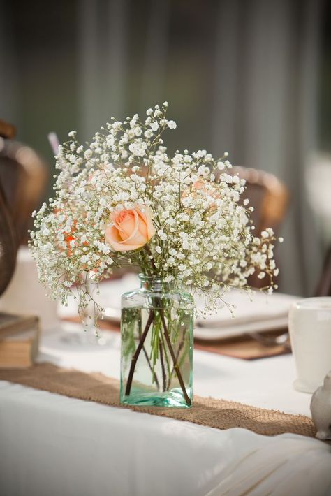 Simple flower arrangements of baby's breath with colored roses in glass vases decorated the reception dining tables. Country Thanksgiving Decorations, Wedding Reception Flower Arrangements, Peach Baby Shower, Simple Invitation, Peach Wedding, Theme Color, Simple Wedding Invitations, Peach Roses, Wedding Arrangements