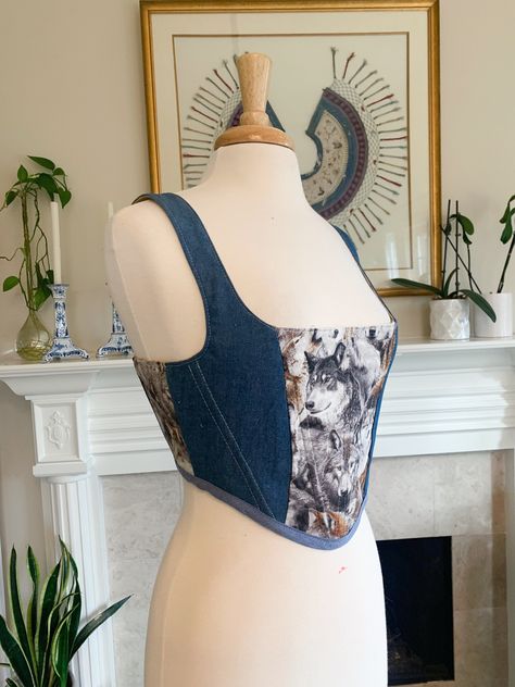 Over-bust corset with flexible boning and white lacing in back.  Two tone denim with a wolf print cotton. It's giving truck stop t shirt chic. Sizing is pretty flexible because of lace-up closure. Message me if you have questions! Beige mannequin's measurements - Waist: 27" Bust: 37" Blue mannequin's measurements - Waist: 31" Bust: 43" Sizes: Small fits a US 4-8 (as seen in photos 1-5) Medium fits a US size 6-12 Large fits a US 12-16 (as seen in photos 6-7) Please send me your bust and waist measurements when ordering so I can make sure it will fit perfectly! Truck Stop, Corset Sewing Pattern, Wolf Print, Corset Fashion, Denim Corset, A Wolf, Costume Hats, Corsets, Printed Cotton