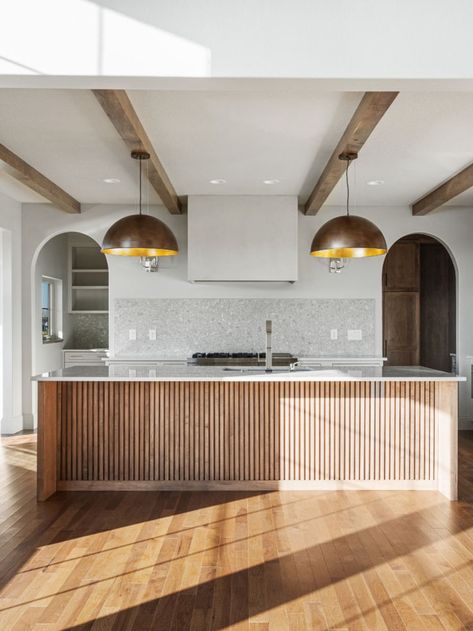 Wooden accents on kitchen islands add texture and color. We love this kitchen island combination with the wooden beams and brass pendent lights. Kitchen Island Paneling Ideas, Wood Slat Kitchen Island, Wood Slat Kitchen, Wooden Island Kitchen, Kitchen Island End Panels, Kitchen Island Panels, Waterfall Island Kitchen, Pendent Lights, Slate Kitchen