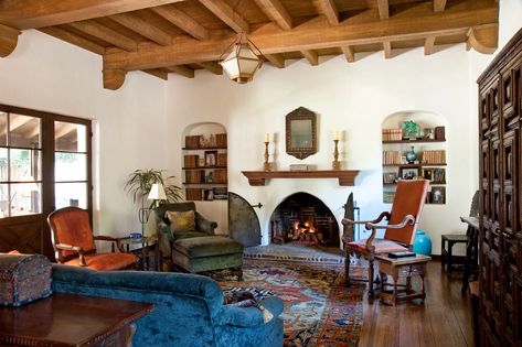 Clay Tiles, Wood and Stucco—Owners Revive L.A.’s Spanish Colonial-Style Homes - Mansion Global Arched Bookshelves, Mexican Living Room, Spanish Living Room, Spanish Style Home Interior, Spanish Home Interior, Stucco Fireplace, Spanish Colonial Revival, Spanish Style Decor, Gorgeous Living Room