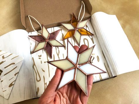 Gift Box of three upcycled stained glass Christmas ornaments! These eco-friendly recycled glass stars can be a lovely suncatcher or part of your Holiday decoration. You might also like https://www.etsy.com/shop/DasimaStudio?ref=seller-platform-mcnav§ion_id=33017073 These stars are made in copper foil stained glass and wire, with vintage finishing details. Stands 11 cm tall /4.3 inch/. The set is gift packed and is ready to placed under the tree! Lovely and unique gift, even just for yourself! - Stained Glass Christmas Ornaments, Star Suncatcher, L'art Du Vitrail, Barn Quilt Designs, Stained Glass Decor, Stained Glass Ornaments, Glass Making, Stained Glass Suncatchers, Stained Glass Christmas