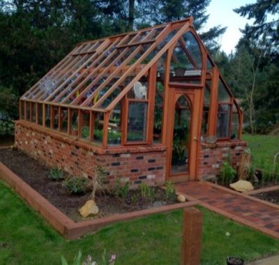 Redwood greenhouse on brick base in Port Orchard WA Brick Greenhouse, Homestead Prepping, Forest Gardening, Greenhouse Pictures, Underground Greenhouse, Greenhouse Diy, Greenhouse Farming, Victorian Greenhouse, Green House Design