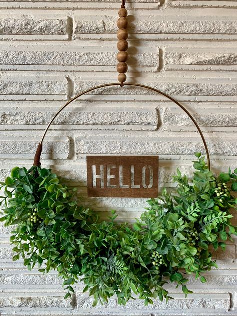 "Greet your guests with a beautiful \"HELLO\" Eucalyptus & Berry Mix Hoop Wreath! 🌿THE WREATH Hoop wreaths are beautiful, minimalistic, and versatile. They can be hung on a wall or door and go with nearly any decor. Eucalyptus stems and other leaves are attached to the gold hoops via floral tape and small amounts of hot glue for added durability. A hand stained wood \"HELLO\" sign is attached via clear line at the center of the wreath. Perfect way to greet those at your door! **On the back Nature Wreaths, January Wreath, Boho Deck, Rustic Cottage Decor, Hoop Wreaths, Wreath Inspiration, Small Porch, Eucalyptus Stems, Christmas Decs