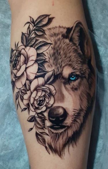 Wolf Tattoos - What's their Meaning? PLUS Ideas & Photos Wolf Tattoo With Blue Eyes, Wolf Calf Tattoos Women, Wolf Ankle Tattoos For Women, Wolf Tattoo Leg Woman, Grey Wolf Tattoo For Women, Tattoos Wolf Woman, Wolf Tattoo On Back For Women, Woman's Wolf Tattoo, Tatoos Wolf For Women