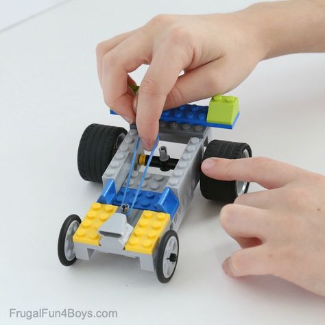 Rubber Band Powered Lego Car - Frugal Fun For Boys and Girls Rubber Band Charms, Lego Party Games, Rubber Band Car, Lego Wedo, Lego Challenge, Lego Club, Lego Diy, Lego Activities, Lego Craft