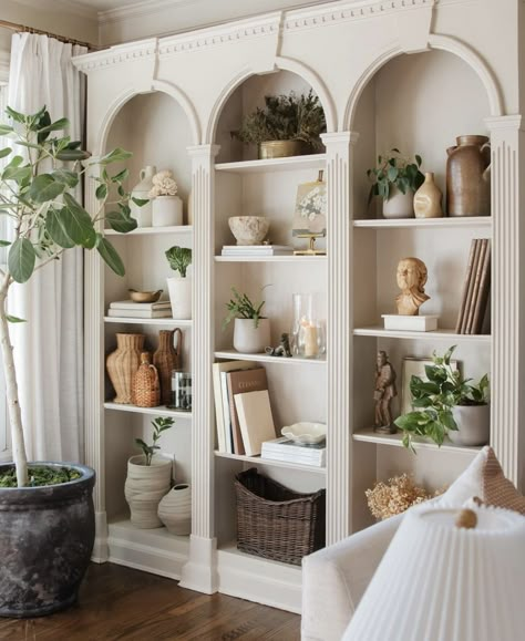 Bookcase And Plants, Curved Shelves Built Ins, French Provincial Bookshelf, Arch Shelves Built Ins, Built In Shelves With Arch, Arched Book Shelf, Arched Bookcases Beside Fireplace, Arched Shelf Built In, Arched Tv Wall