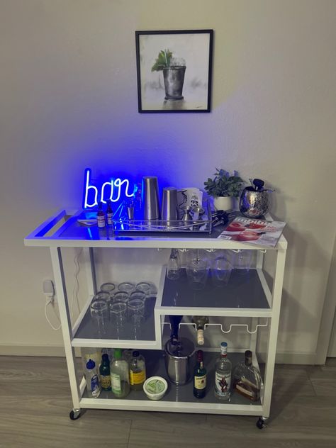 Mini Bar In Bedroom, Alcohol Cart Aesthetic, Liquor Cart Ideas, Black Bar Cart Aesthetic, Mini Bar Ideas Small Spaces, Bev Cart Apartment, Neon Sign Bar Cart, Bar Cart Accessories Silver, Dorm Room Desk