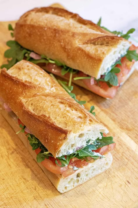 No cooking required for this easy veggie-packed sandwich! Our Tomato Arugula Baguette Sandwich has fresh tomatoes, peppery arugula, pickled onions, nutty cheese, and a basil butter spread, making it a delicious and healthy vegetarian baguette sandwich! French Baguette Sandwich Ideas, Basil Butter, Baguette Sandwich, Baguette Recipe, Healthy Sandwich Recipes, Fresh Tomato Recipes, Sandwich Burger, Breakfast Platter, Vegetarian Sandwich