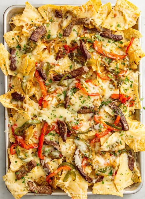 Cheesesteak Nachos vertical Cheesesteak Nachos, Best Philly Cheesesteak, Steak Nachos, How To Make Nachos, Steak Dinner Recipes, Nacho Toppings, Nachos Recipe Easy, Superbowl Appetizers, Fast Foods