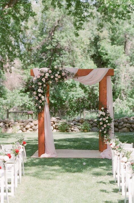 Sheridan, WY destination wedding florist draped pale pink fabric on this large wedding arch and created flowers in blush tones with roses, ruscus and eucalyptus at the Brinton Museum for a June wedding in Burgundy and Blush with navy accents. Wedding arch, arbor with two floral pieces in asymmetrical design Gold Wedding Ceremony Decor, Wedding Ceremony Arbor, Ceremony Arch Flowers, Blush And Burgundy Wedding, Outside Wedding Ceremonies, Wedding Arbors, Wedding Alters, Wedding Arbor, Cottage Wedding