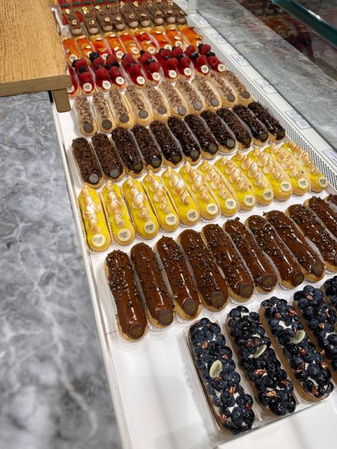 Eclairs of various colours in Paris Eclair Photography Styling, Paris Eclairs, Paris Pastries Aesthetic, French Street Food Paris, Le Marais Paris Restaurants, Paris Food, Emily In Paris, Eclairs, Camera Roll