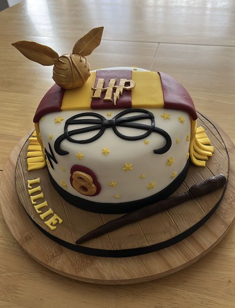 Harry Potter themed cake with the golden snitch,scarf and wand. All handmade . Harry Potter Party Cake, Easy Harry Potter Cake, Snitch Cupcakes, Harry Potter Cakes Birthday, Golden Snitch Cake, Harry Potter Cakes, Harry Potter Snitch, The Golden Snitch, Harry Potter Birthday Cake